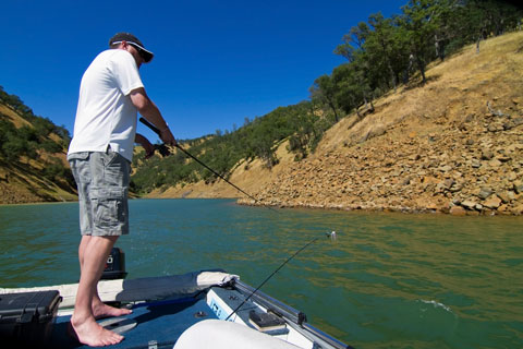 man fishing fom a boat